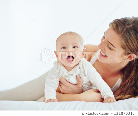 Loving mother and baby bonding at home, playing while relaxing on a bed together. Happy parent being affectionate with her newborn son, embracing him and sharing precious moments of parenthood Loving mother and baby bonding at home, playing while relaxing on a bed together. Happy parent being affectionate with her newborn son, embracing him and sharing precious moments of parenthood 121876313