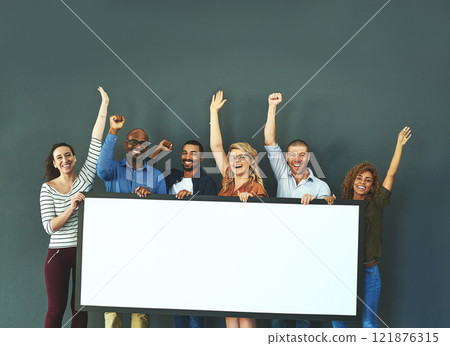 Excited business people showing a blank sign, promoting a product and giving a message on a board while standing together in an office at work. Portrait of happy colleagues holding an empty poster Excited business people showing a blank sign, promoting a product and giving a message on a board while standing together in an office at work. Portrait of happy colleagues holding an empty poster 121876315