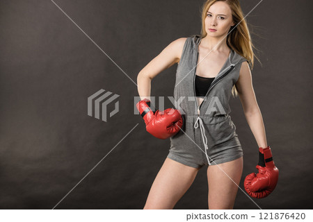 Beautiful woman with red boxing gloves 121876420