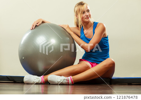 woman doing fitness exercises with fit ball woman doing fitness exercises with fit ball 121876478