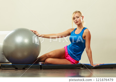 woman doing fitness exercises with fit ball woman doing fitness exercises with fit ball 121876479