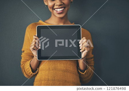 Woman holding digital tablet with a blank screen, copy space or chromakey for online advertising. Creative female with plain touch screen, branding for business logo or news and marketing. Woman holding digital tablet with a blank screen, copy space or chromakey for online advertising. Creative female with plain touch screen, branding for business logo or news and marketing. 121876498