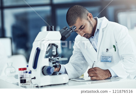 Serious male scientist writing on a tablet for an online phd research paper in a lab. Laboratory worker working on health data for a science journal. Medical professional analyzing test results 121876516