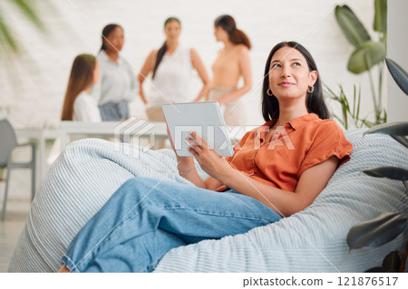 Thinking, idea and wondering female employee sitting and browsing on a tablet in an office. A young happy woman marketing agency worker looking into the distance and searching the internet online 121876517