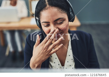 Young call centre agent covers their mouth to hide their smile. The client makes the employee happy with their positive feedback or joke. Building a professional and friendly relationship online. Young call centre agent covers their mouth to hide their smile. The client makes the employee happy with their positive feedback or joke. Building a professional and friendly relationship online. 121876645