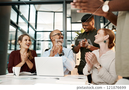 Excited business people clapping in meeting, celebrating success and cheering for good teamwork while working on a laptop together at work. Colleagues having fun after victory and showing support 121876699