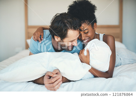 Fun interracial couple laughing, bonding and lying on bed in a home bedroom and looking happy, in love and playful. Smiling man and woman hugging and cuddling after waking up in the morning together Fun interracial couple laughing, bonding and lying on bed in a home bedroom and looking happy, in love and playful. Smiling man and woman hugging and cuddling after waking up in the morning together 121876864