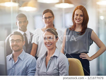 Portrait of a group of a diverse corporate group standing in an office. Happy smiling colleagues motivated and dedicated to success. Cheerful and ambitious team working together in a startup agency 121877078