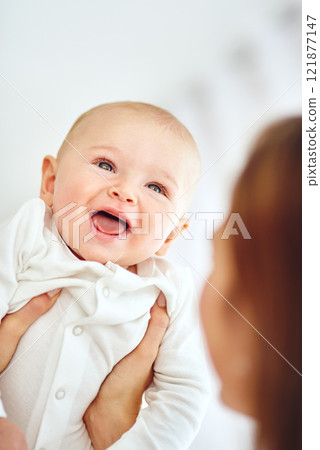 Cute, little and happy baby in the arms of his mother or single parent. Innocent, pure and adorable newborn infant with his mom. Bonding together as a family with love, affection and happiness Cute, little and happy baby in the arms of his mother or single parent. Innocent, pure and adorable newborn infant with his mom. Bonding together as a family with love, affection and happiness 121877147