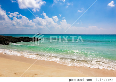 Emerald green sea, white sand and blue sky seen at Toguchi Beach on Irabu Island 121877468