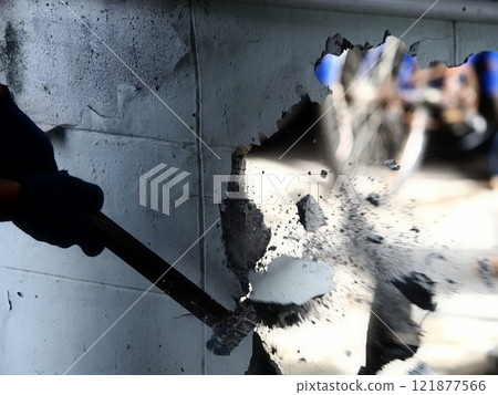 worker hit wall by iron hammer worker hit wall by iron hammer 121877566