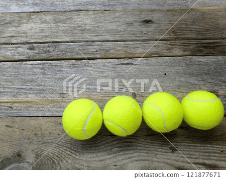 Creative sports scene with tennis balls on wooden table 121877671