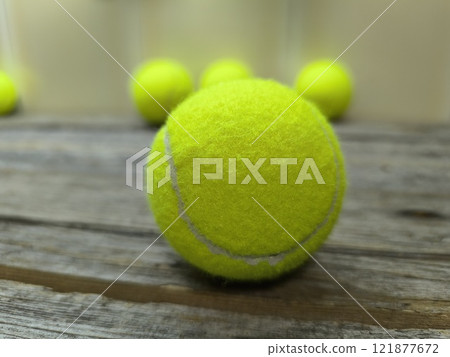 Creative sports scene with tennis balls on wooden table 121877672