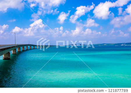Irabu Bridge spanning the emerald green ocean and clouds floating in the blue sky, seen from Miyako Island Irabu Bridge spanning the emerald green ocean and clouds floating in the blue sky, seen from Miyako Island 121877789