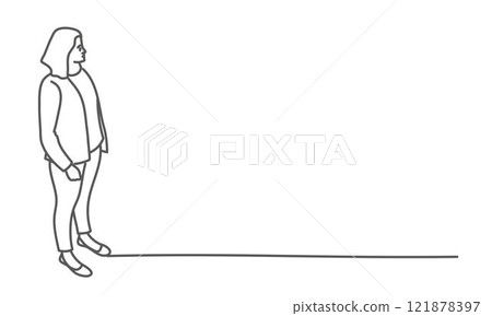 Woman stands in front of a wall, looking at something behind her 121878397