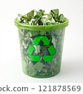A light green plastic bucket filled with crumpled green paper. The bucket has a green recycling symbol on it.	 121878569
