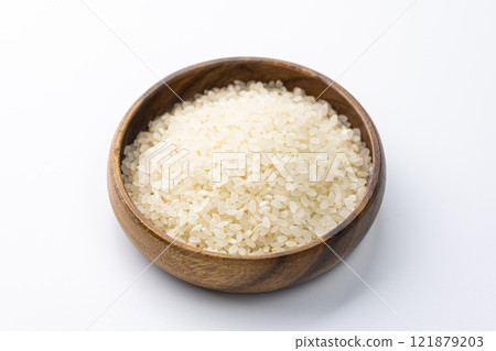 White rice served on a wooden plate on a white background White rice served on a wooden plate on a white background 121879203