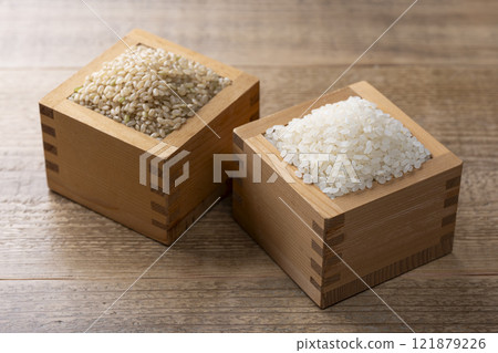 White rice and brown rice served in a wooden box 121879226