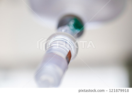Close up medical intravenous IV drip in hospital background 121879918
