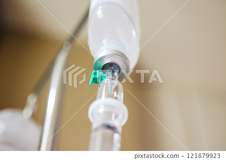 Close up medical intravenous IV drip in hospital background 121879923