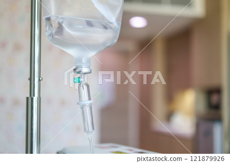 Close up medical intravenous IV drip in hospital background 121879926