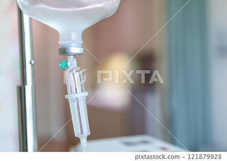 Close up medical intravenous IV drip in hospital background 121879928