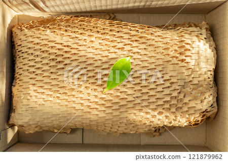 Green leaf on eco friendly brown paper honeycomb wrap for product packaging parcel carton box Green leaf on eco friendly brown paper honeycomb wrap for product packaging parcel carton box 121879962