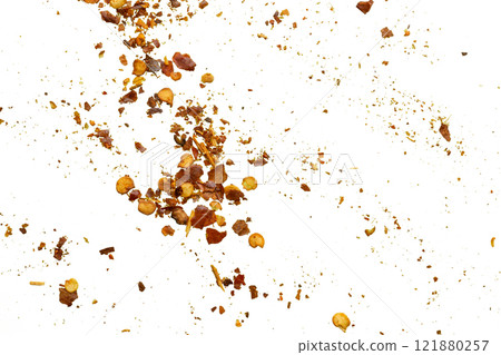 dried red chili pepper flakes and seeds isolated on white background 121880257