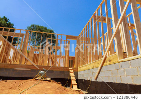 Erecting wooden frame of house under progress works showcasing progress in construction 121880446