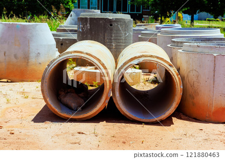 Concrete pipes are scattered in construction area with ready for installation. Concrete pipes are scattered in construction area with ready for installation. 121880463