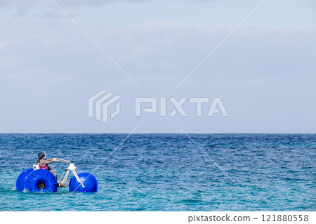 White sand beach, blue sea and sky. Marine activities at Sheraton Okinawa Sunmarina Resort, pedal board 121880558
