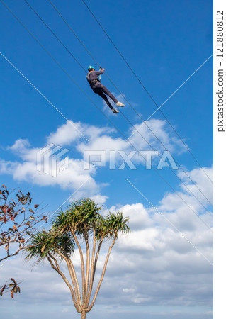 White sand beach, blue sea and sky. Zip line over the sea at Sheraton Okinawa Sunmarina Resort. 121880812