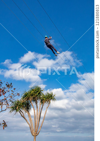 White sand beach, blue sea and sky. Zip line over the sea at Sheraton Okinawa Sunmarina Resort. 121880813