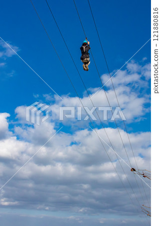 White sand beach, blue sea and sky. Zip line over the sea at Sheraton Okinawa Sunmarina Resort. 121880816