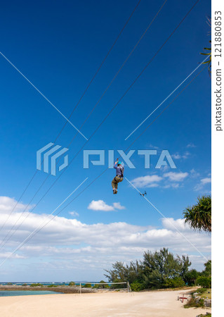 White sand beach, blue sea and sky. Zip line over the sea at Sheraton Okinawa Sunmarina Resort. 121880853