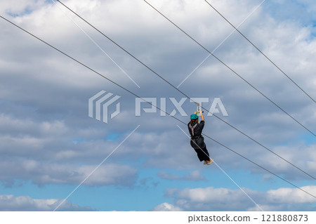 White sand beach, blue sea and sky. Zip line over the sea at Sheraton Okinawa Sunmarina Resort. White sand beach, blue sea and sky. Zip line over the sea at Sheraton Okinawa Sunmarina Resort. 121880873