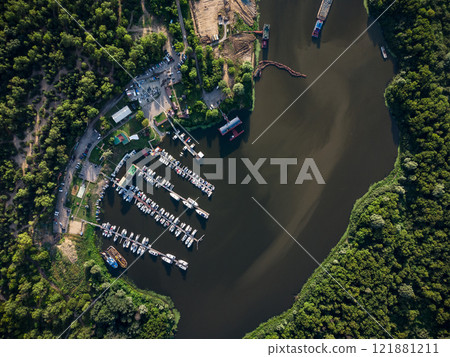 Bird's-eye view of luxury yachts and speedboats in the marina and yacht club. Bird's-eye view of moored sailboats. Bird's-eye view of luxury yachts and speedboats in the marina and yacht club. Bird's-eye view of moored sailboats. 121881211