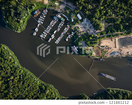 Bird's-eye view of luxury yachts and speedboats in the marina and yacht club. Bird's-eye view of moored sailboats. 121881212