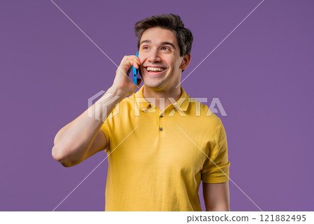 Smiling positive man talking by phone, smiling. Mature guy on violet background. 121882495