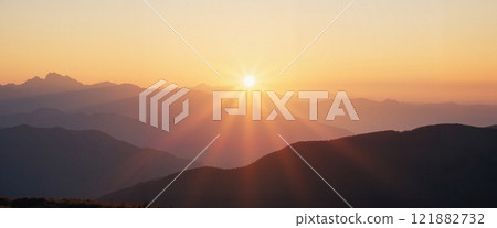 Stunning sunrise over mountain range showcasing vibrant colors and serene landscape in peaceful morning light 121882732