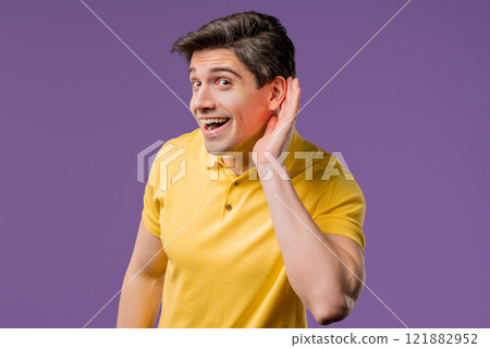 Curious smiling handsome man doesn't hear,asking what.Quiet sound, misunderstand 121882952