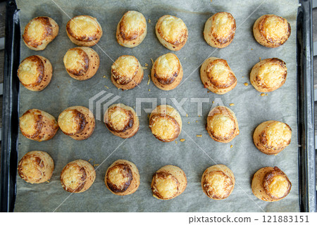 Pogaca stuffed with cheese. A full tray of fresh Pogaca traditional Eastern European salty buns with cheese - Pogace. Pogaca stuffed with cheese. A full tray of fresh Pogaca traditional Eastern European salty buns with cheese - Pogace. 121883151