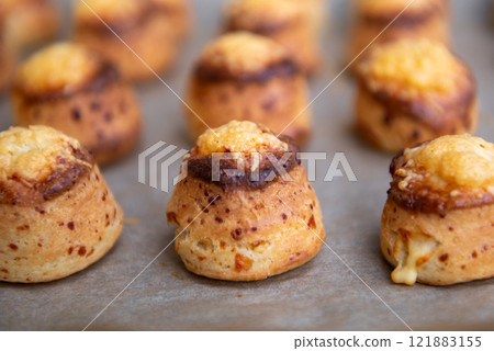 Pogaca stuffed with cheese. A full tray of fresh Pogaca traditional Eastern European salty buns with cheese - Pogace. 121883155