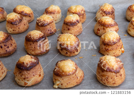 Pogaca stuffed with cheese. A full tray of fresh Pogaca traditional Eastern European salty buns with cheese - Pogace. Pogaca stuffed with cheese. A full tray of fresh Pogaca traditional Eastern European salty buns with cheese - Pogace. 121883156