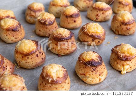 Pogaca stuffed with cheese. A full tray of fresh Pogaca traditional Eastern European salty buns with cheese - Pogace. 121883157