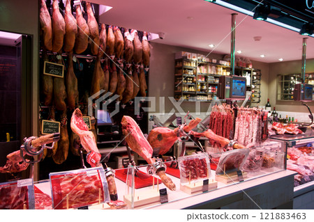 TARRAGONA, SPAIN - AUG 28th, 2017: Butcher working at stall on local market of Mercat Central in the province Tarragona 121883463