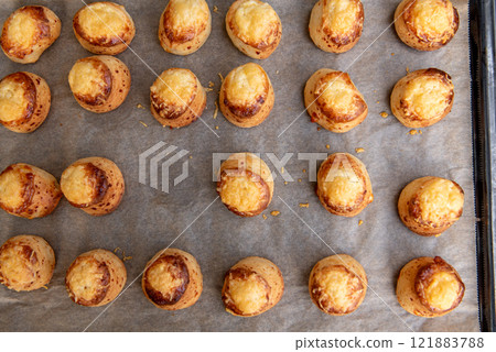 Pogaca stuffed with cheese. A full tray of fresh Pogaca, salty buns with cheese - Pogace. Pogaca stuffed with cheese. A full tray of fresh Pogaca, salty buns with cheese - Pogace. 121883788