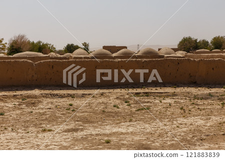 Ancient earthen structures in Jowzjan Province, Afghanistan under clear blue sky 121883839