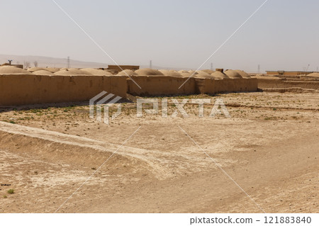 Mud brick structures in Jowzjan Province, Afghanistan under a clear sky 121883840