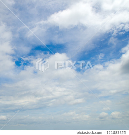 Blue sky with light, cumulus clouds. Blue sky with light, cumulus clouds. 121883855